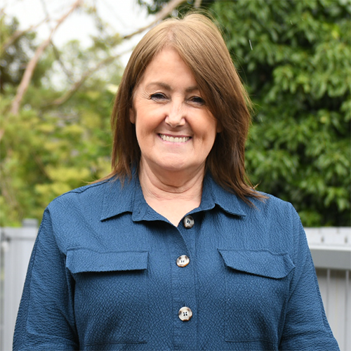An image of Advisory Panel Member, Wyn. A headshot of a smiling lady with short brown hair.