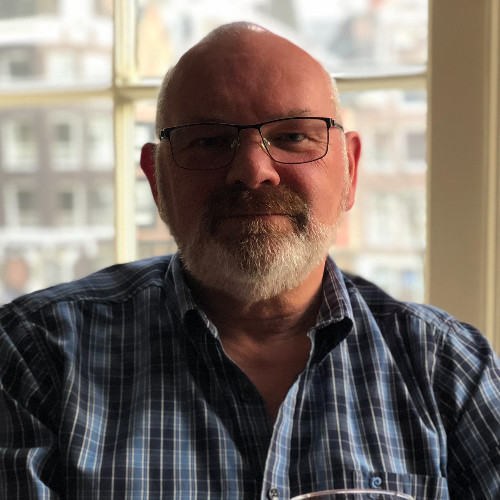 An Image of Advisory Panel Member, John. A headshot of a smiling male with glasses and a beard.